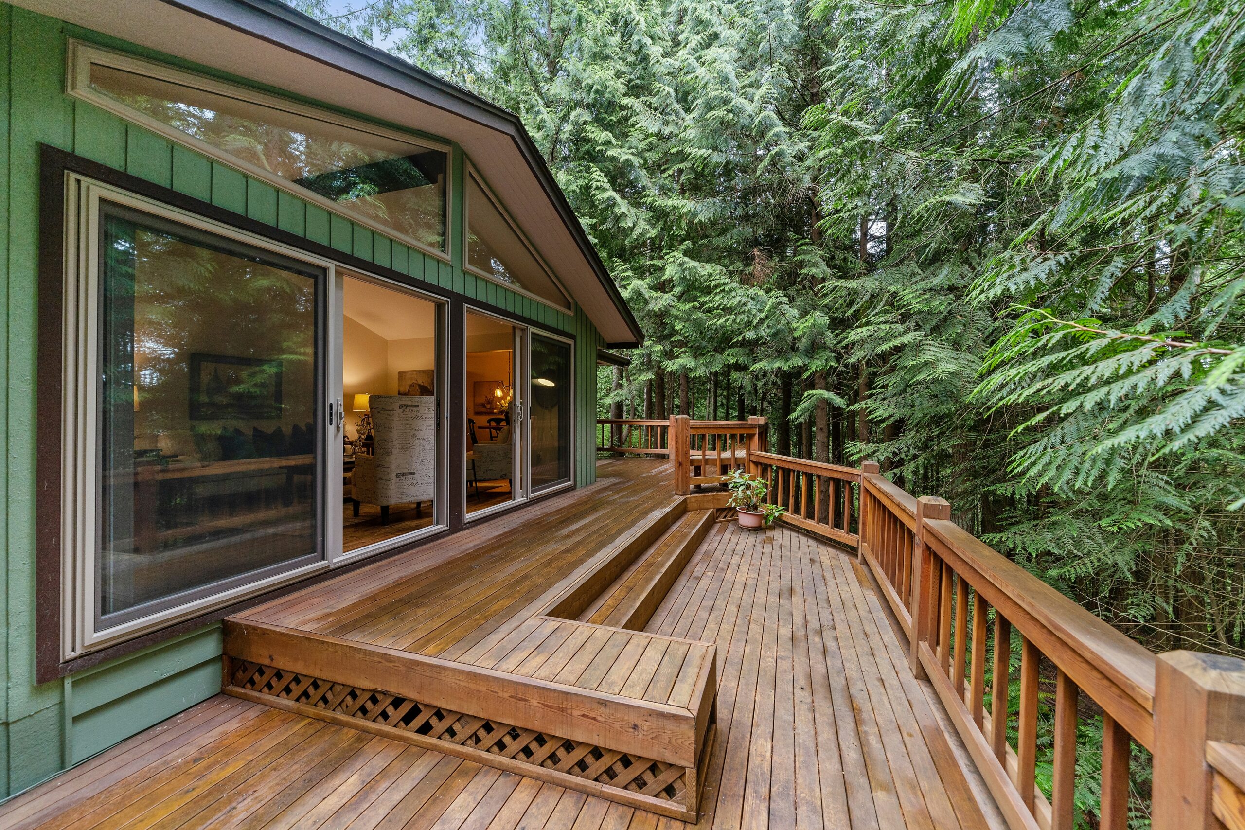 Wooden deck surrounded by trees and outdoor greenery