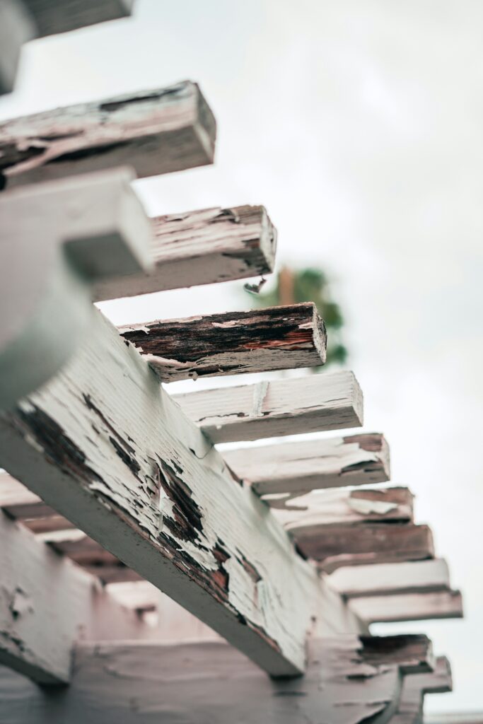 Close-up of peeling paint on exterior wood trim