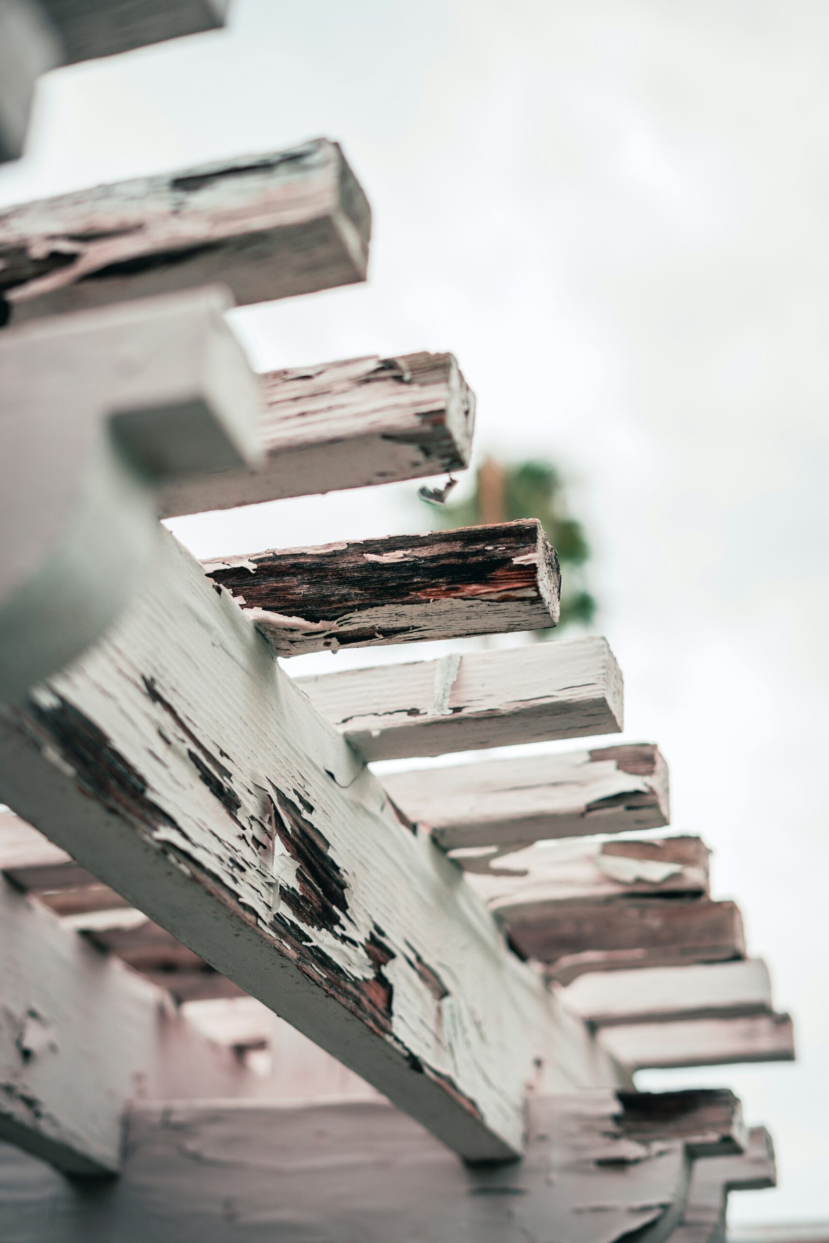 Close-up of peeling paint on exterior wood trim
