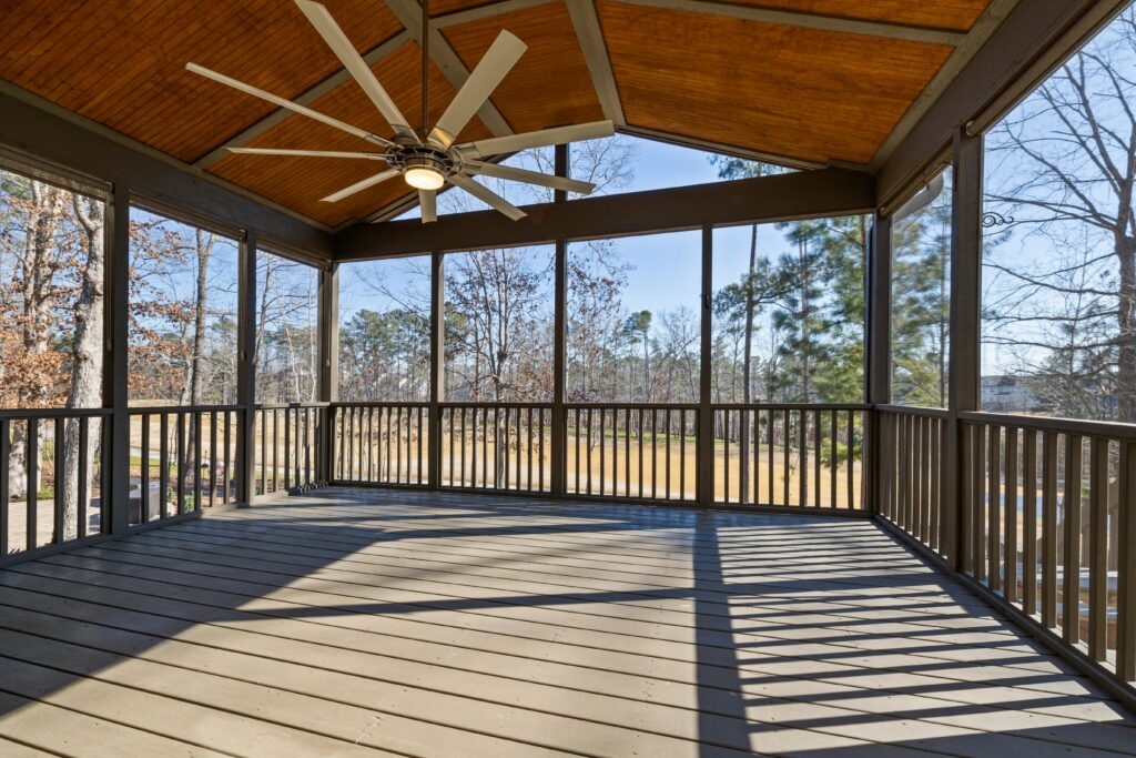 How Wood Rot Starts and Why It Spreads Covered wooden deck with railings and large windows
