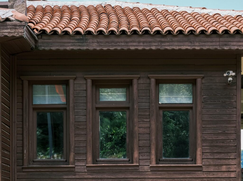 Dark weathered wood siding with exterior windows