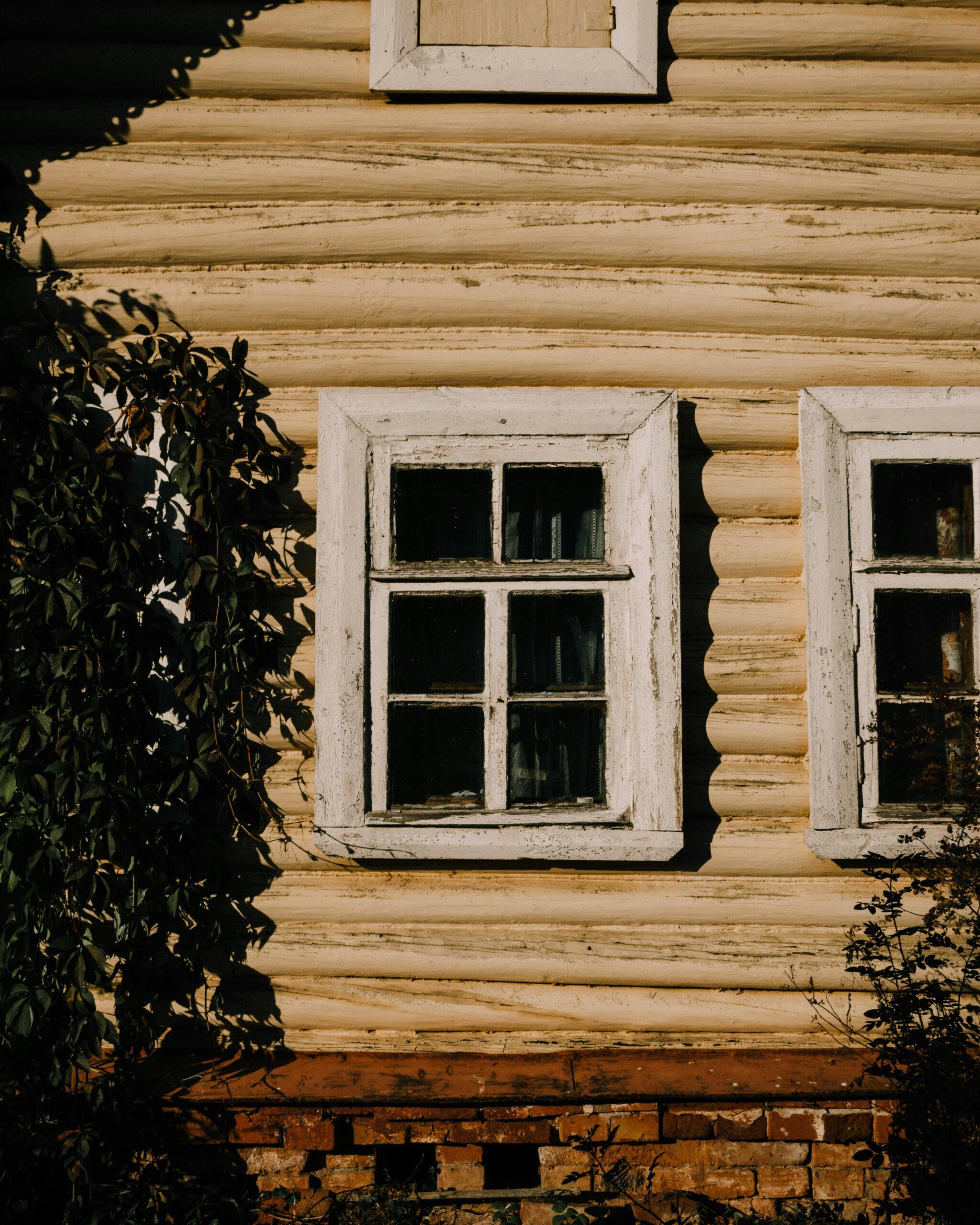 Weathered wood window frame on an older exterior wall